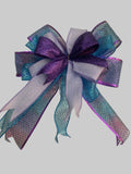 Decorative bow with purple and blue hues on a textured surface